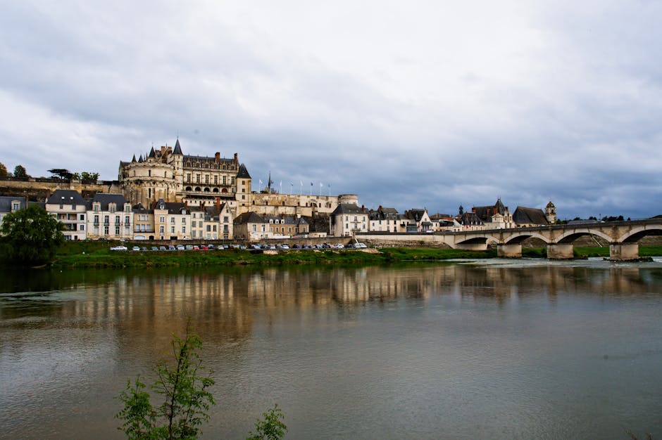 Scenic view of Château d'Amboise over the Loire River in France with a historic bridge